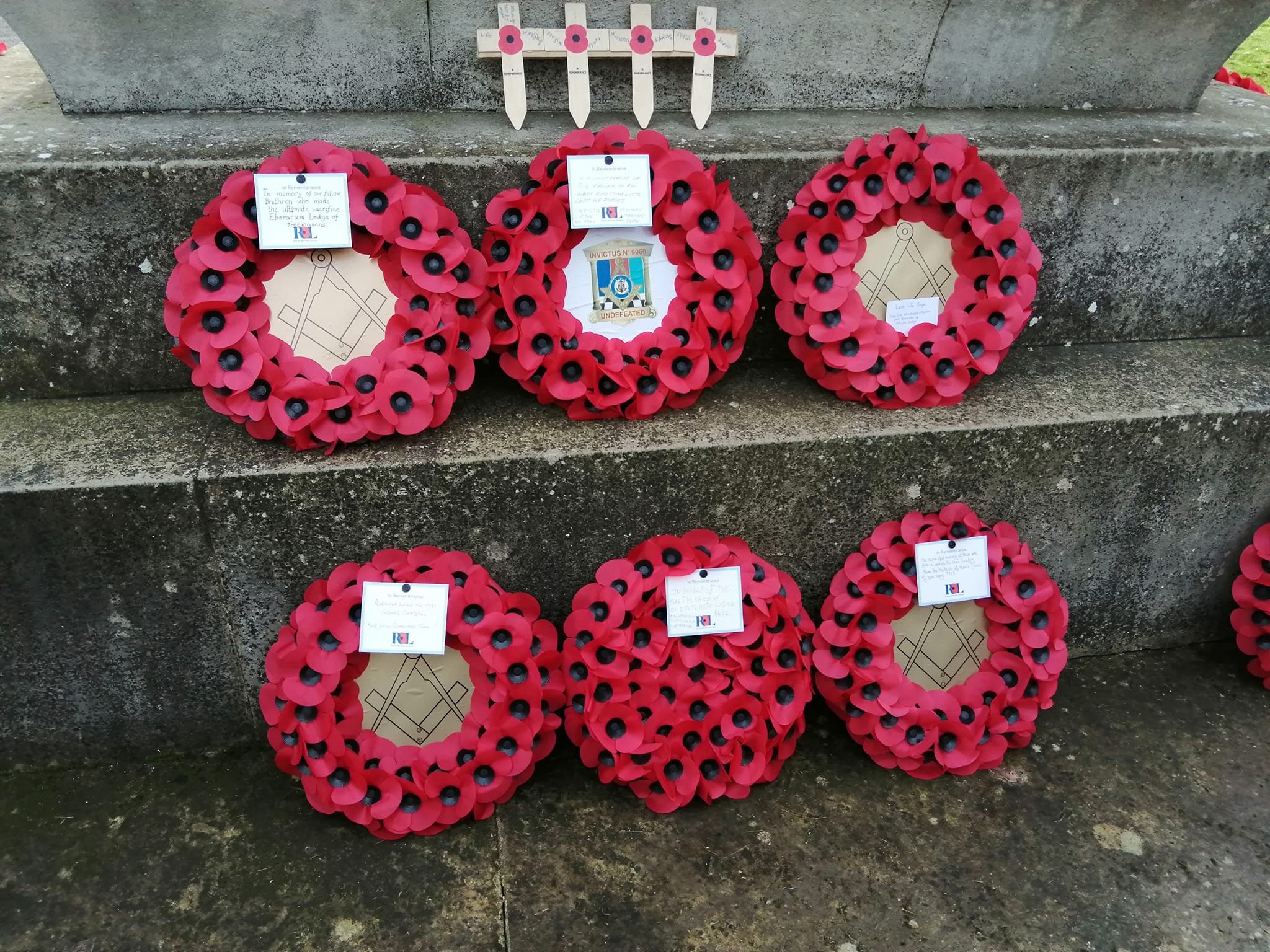 six wreaths on a memorial
