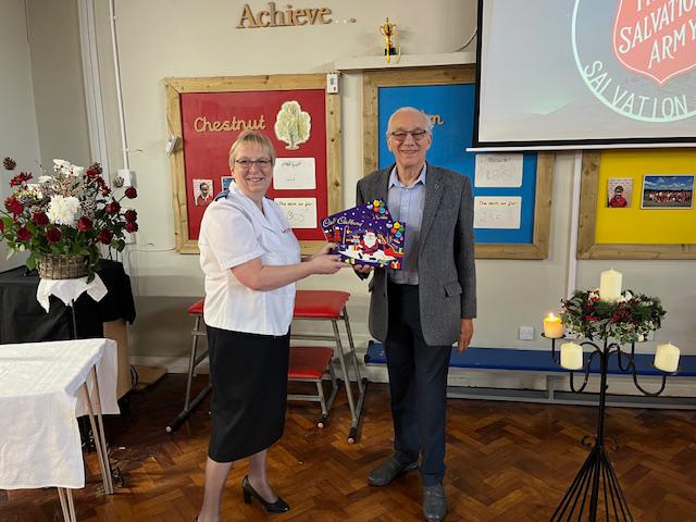 man and woman stood holding christmas selection boxes